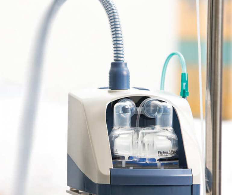 Photo of the AIRVO 2 on a table with a blurred background behind it.